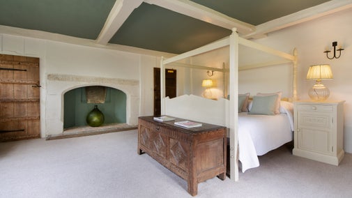 Bedroom 2 'Strutt,' with a super king-size, four-poster bed and en-suite shower room, on the first floor of Thorington Hall, Suffolk